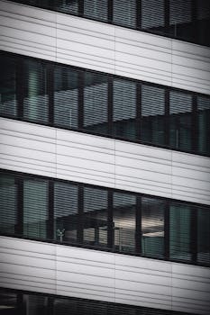 Abstract view of modern office building facade with reflecting glass windows in Hamburg, Germany.