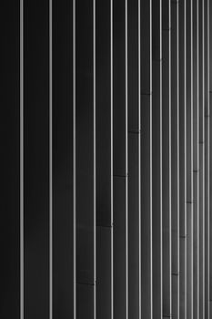 Minimalist black and white abstract architecture photo with vertical lines and shadows in Hamburg, Germany.