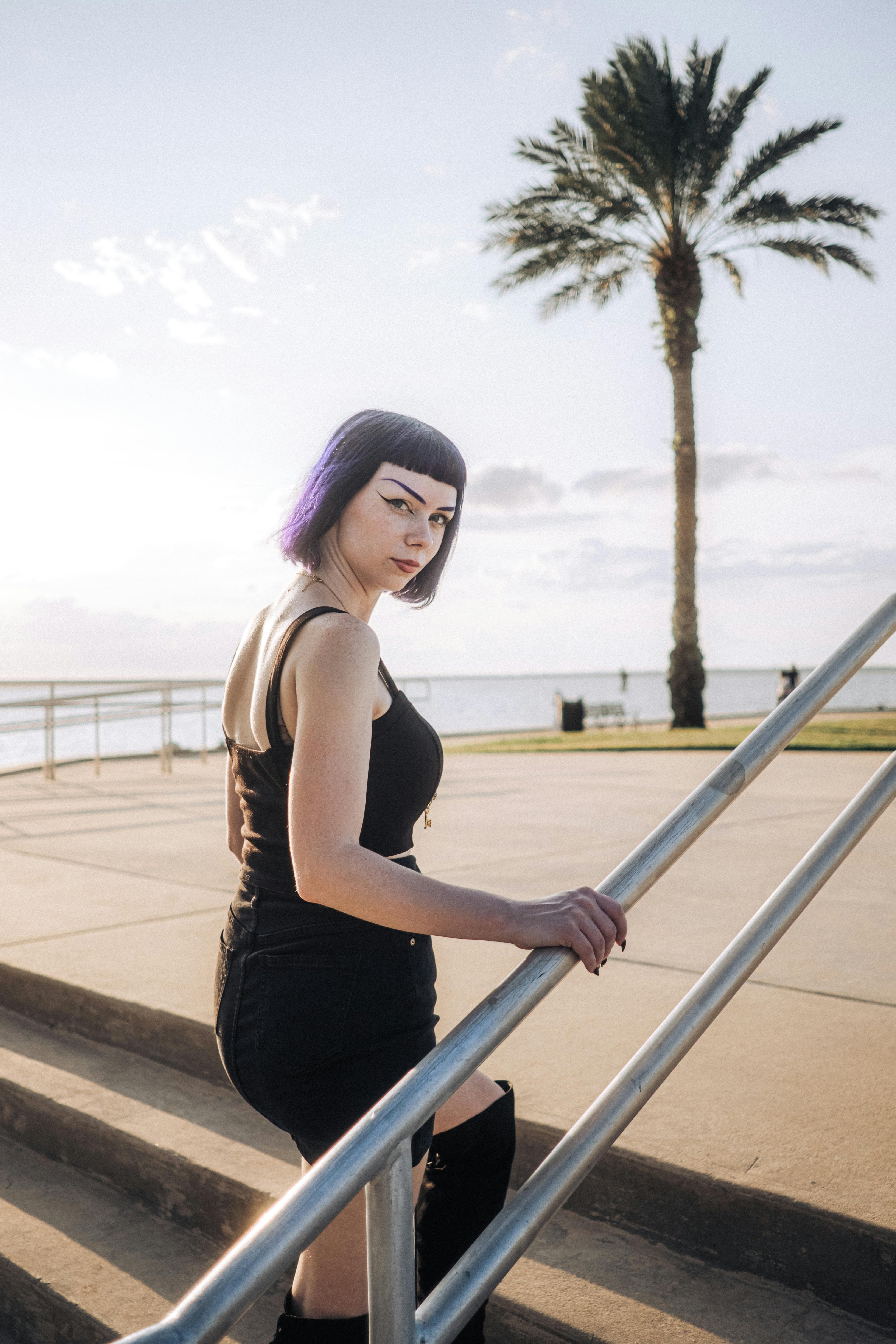 woman in black tank top walking up the stairs