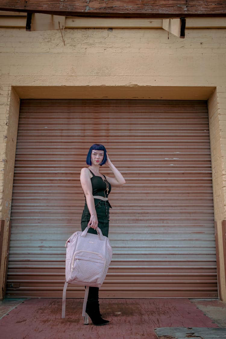 Stylish Woman Holding A Pink Bagpack 