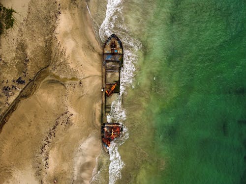 View of Wreckage of Merchant Ship Lying on Sea Shore