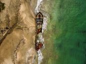 View of Wreckage of Merchant Ship Lying on Sea Shore