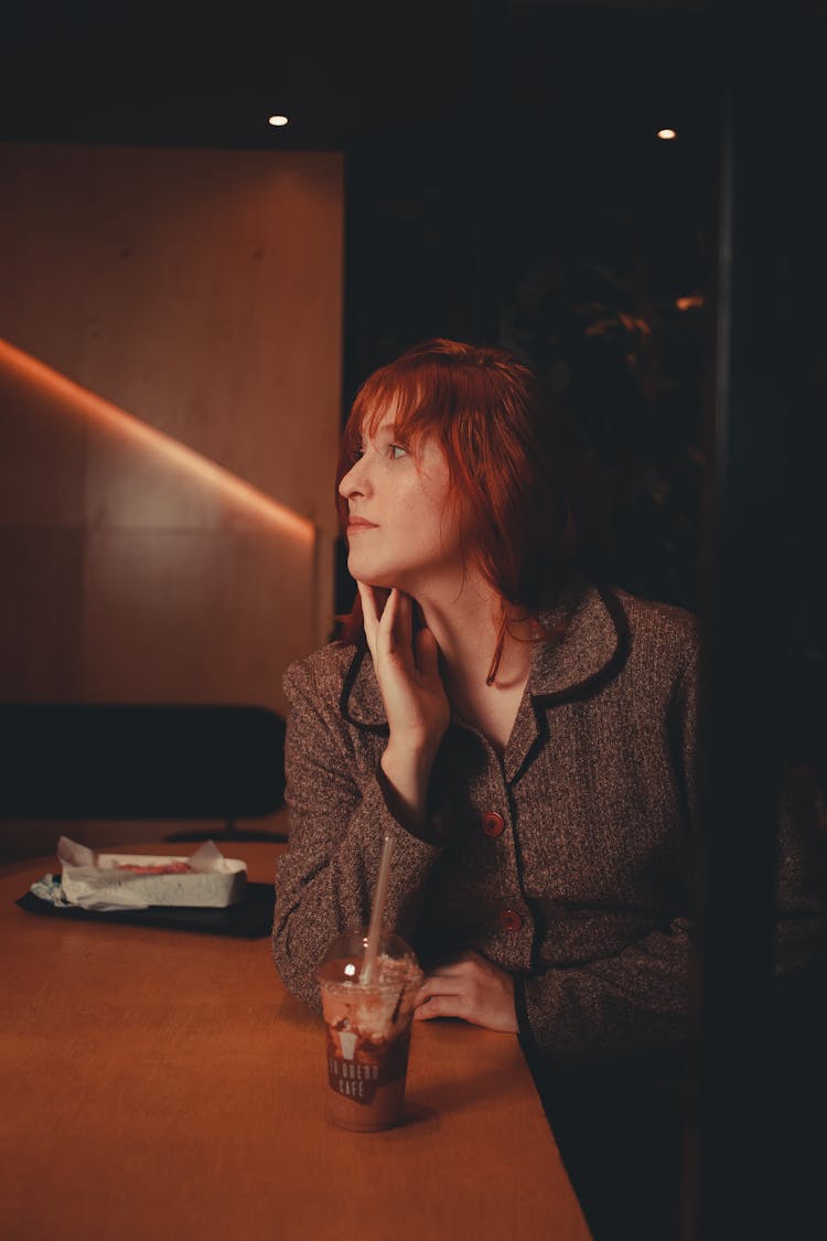 Woman Sitting By The Counter With A Dessert 