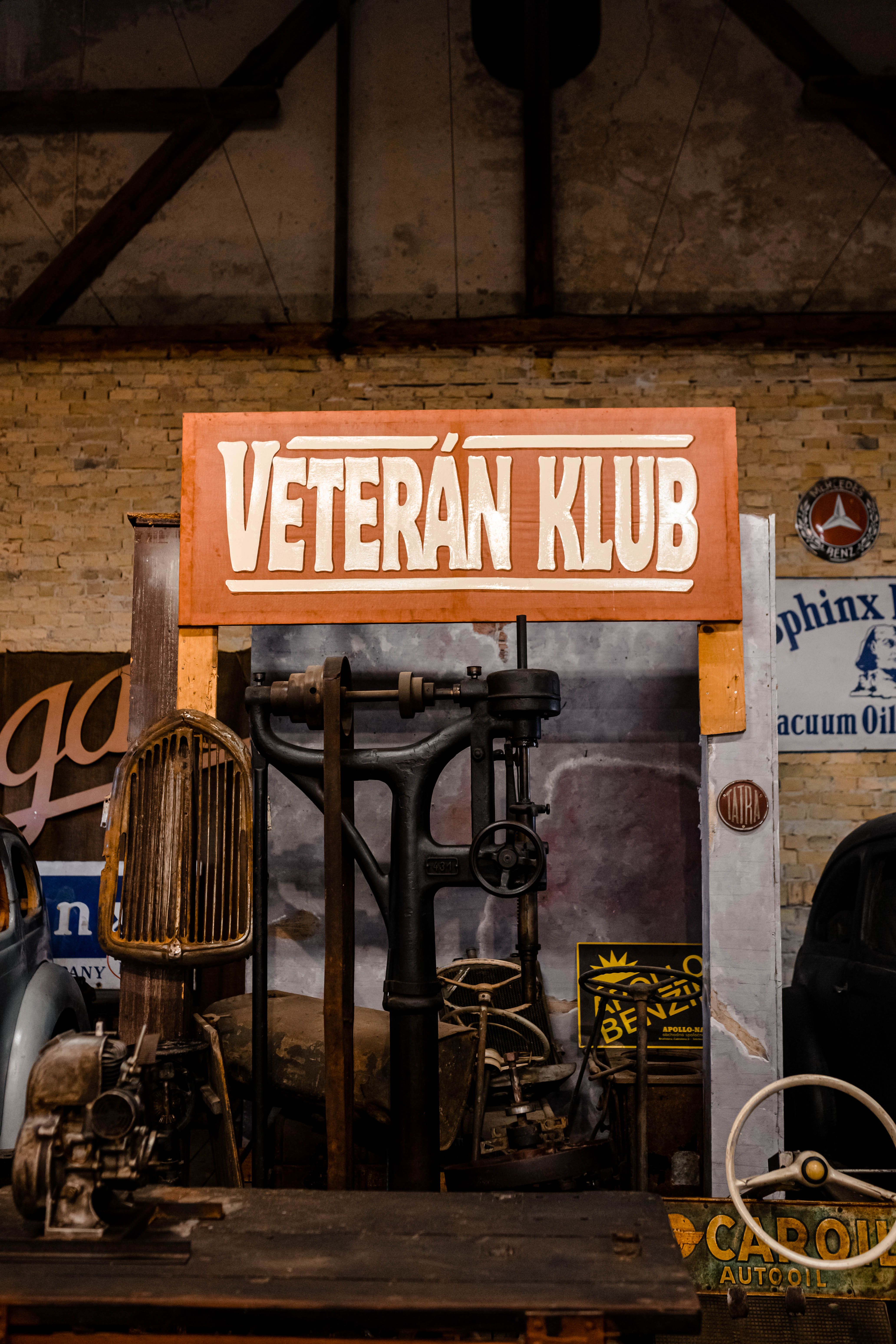 Close-up of antique engine and machinery with signage at Veterán Klub.