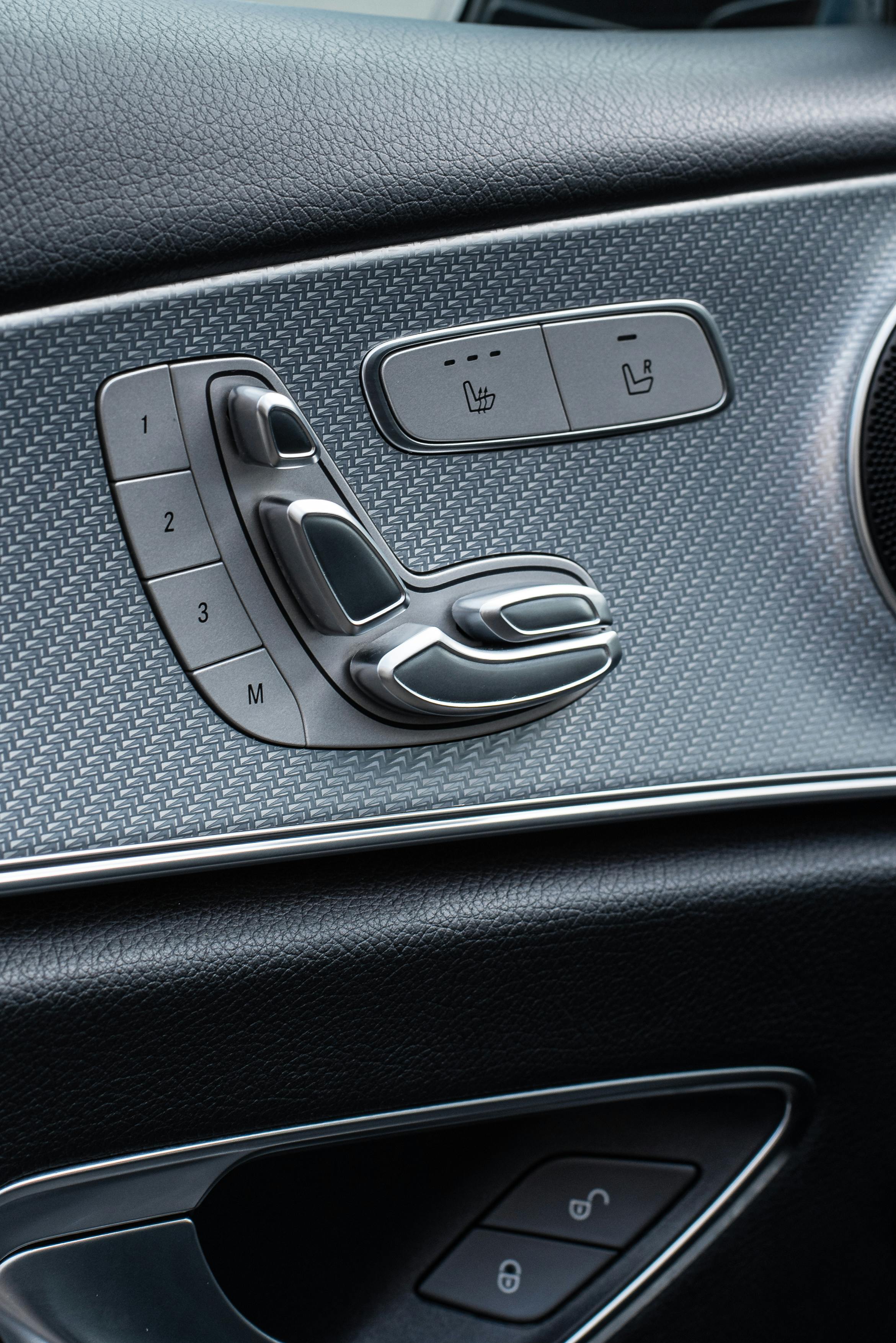 Free Detailed view of a luxury car's interior control panel featuring seat adjustment and heating buttons. Stock Photo
