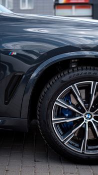 Detailed view of a BMW car fender and wheel rim highlighting luxury automotive design.