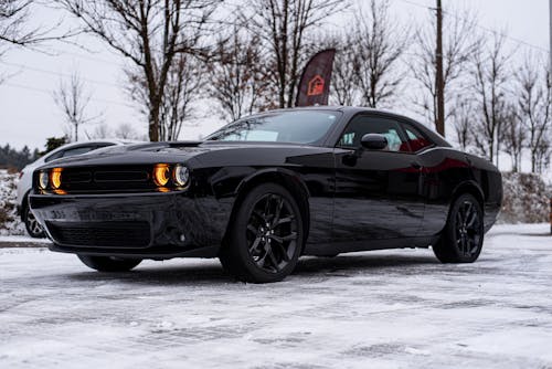 Black Dodge Challenger Parked in a Snow-covered Driveway