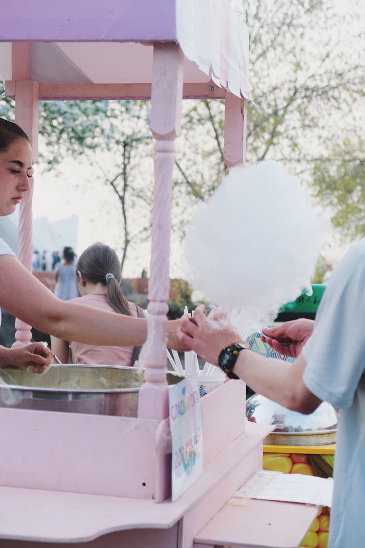 Seller Giving Candyfloss To Client