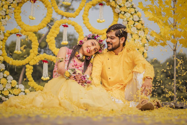 A Smiling Couple At A Haldi Ceremony 