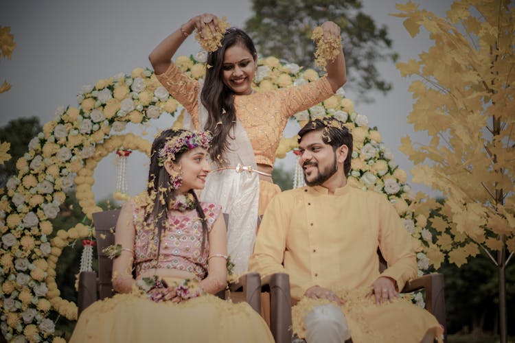 Woman Showering Newlyweds With Flowers