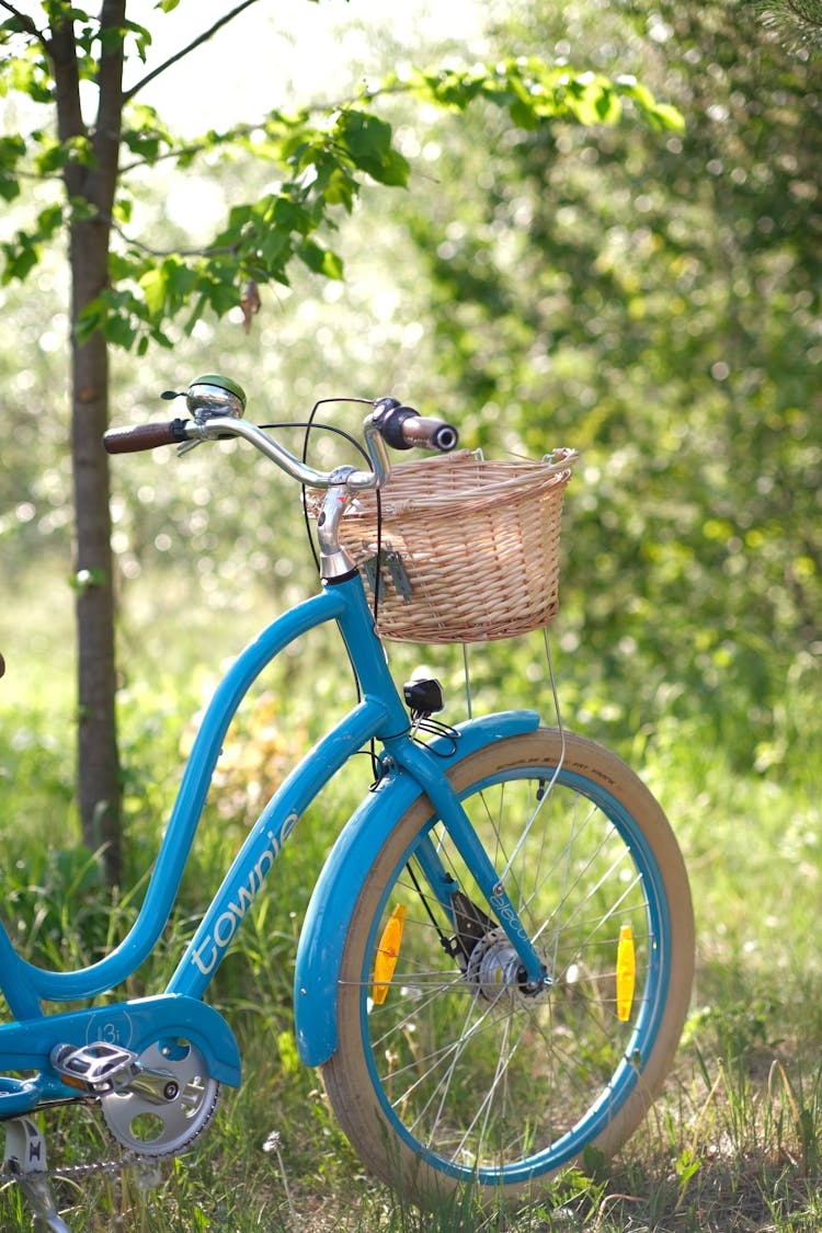 A Blue Bicycle With Woven Basket