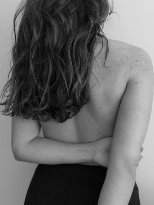 A Grayscale Photo of a Topless Woman