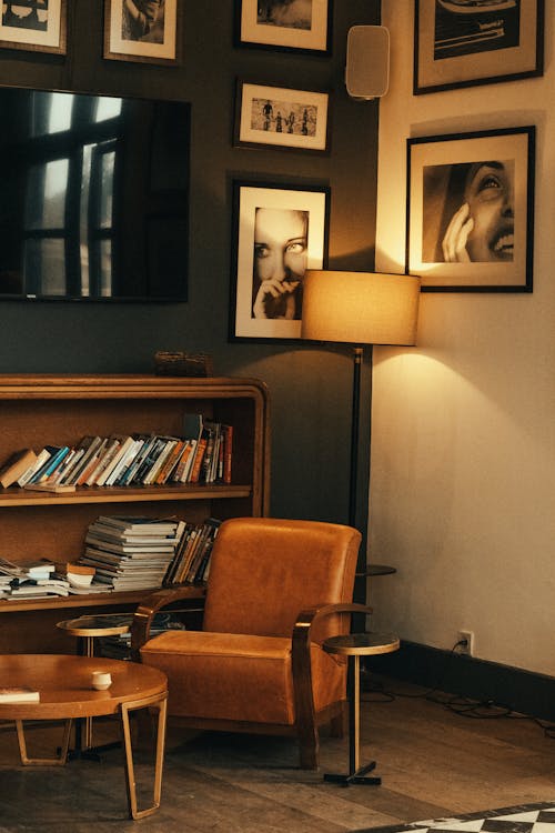 A Lighted Floor Lamp and Wooden Furniture in a Room