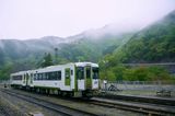 Local train crossing a hillside valley — photo by Han Sen on Pexels