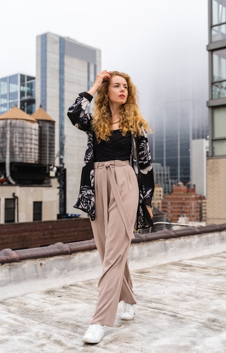 Blonde Fashion Woman Walking On Roof Of Building