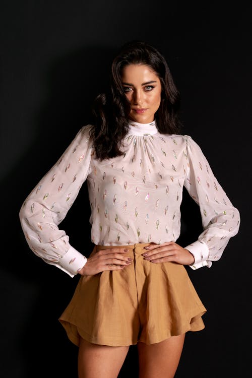 Woman in White Printed Long Sleeves and Brown Skirt
