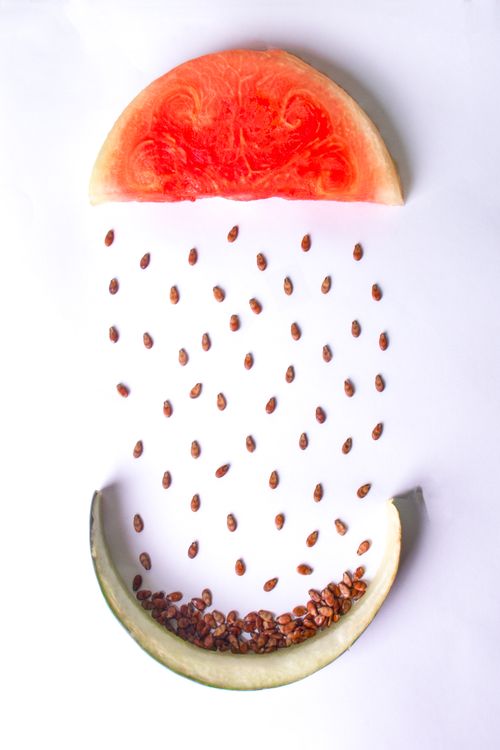 Free Artistic arrangement of watermelon slices with seeds on white background, creating an imaginative pattern. Stock Photo