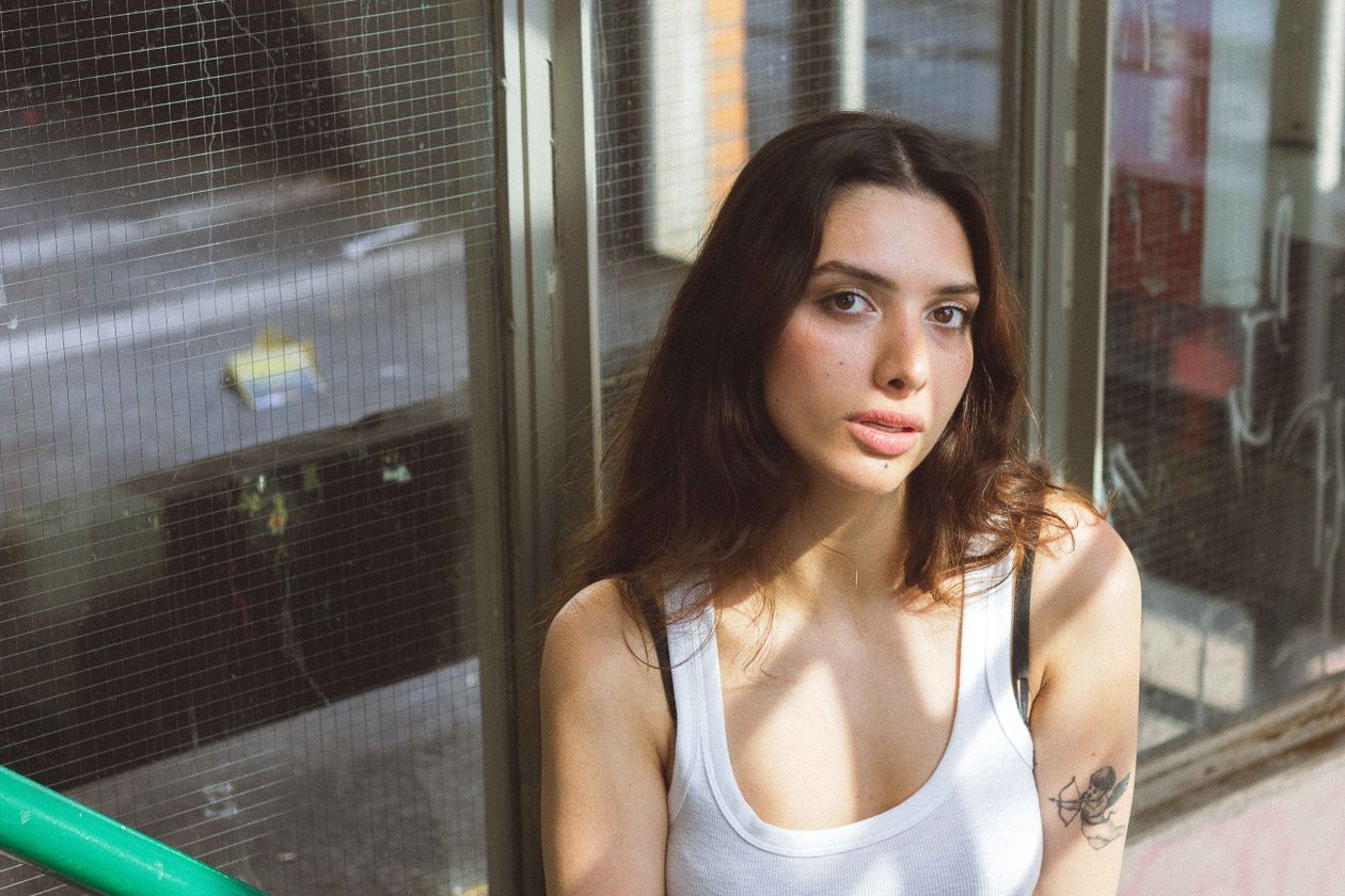 Woman by window, soft light, reflective mood