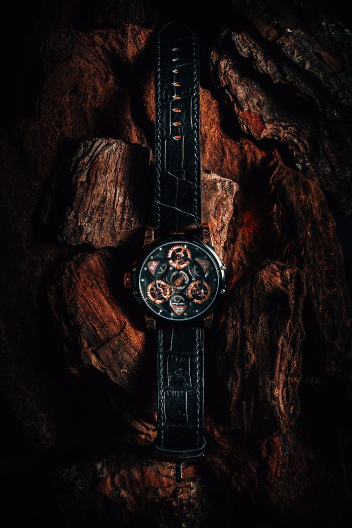 Skeleton-dial watch on dark bark, photo by Rafael Nicida on Pexels