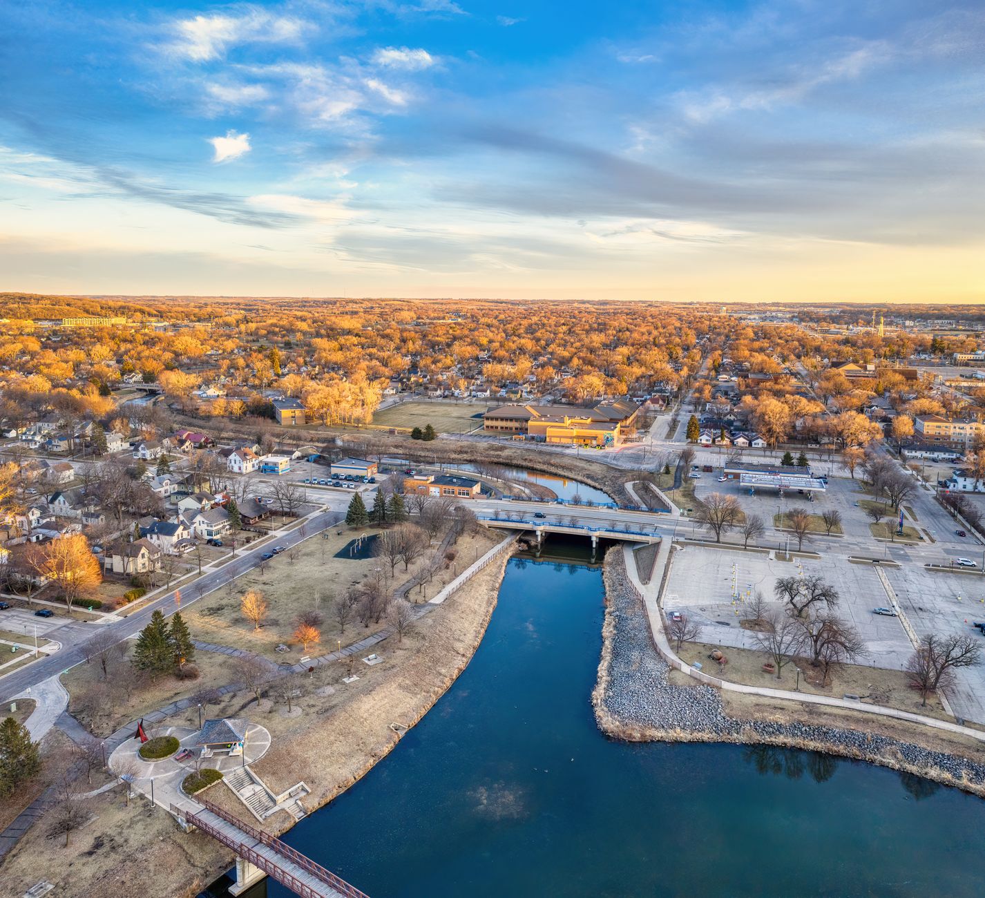 Scenic aerial view of Rochester, Minnesota highlighting the cityscape and river at sunset.
