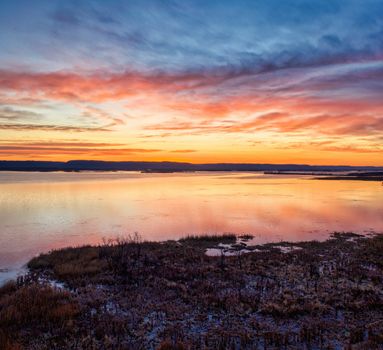 Captivating sunset reflections on a calm lake in Weaver, Minnesota, with colorful skies and serene waters.