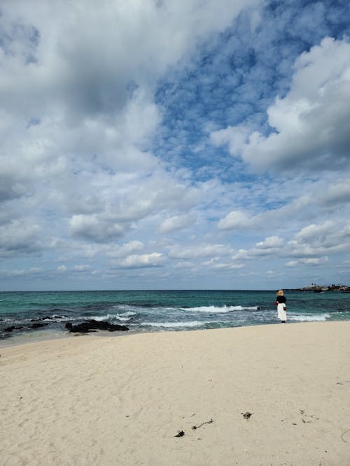 A Woman Standing on Seashore