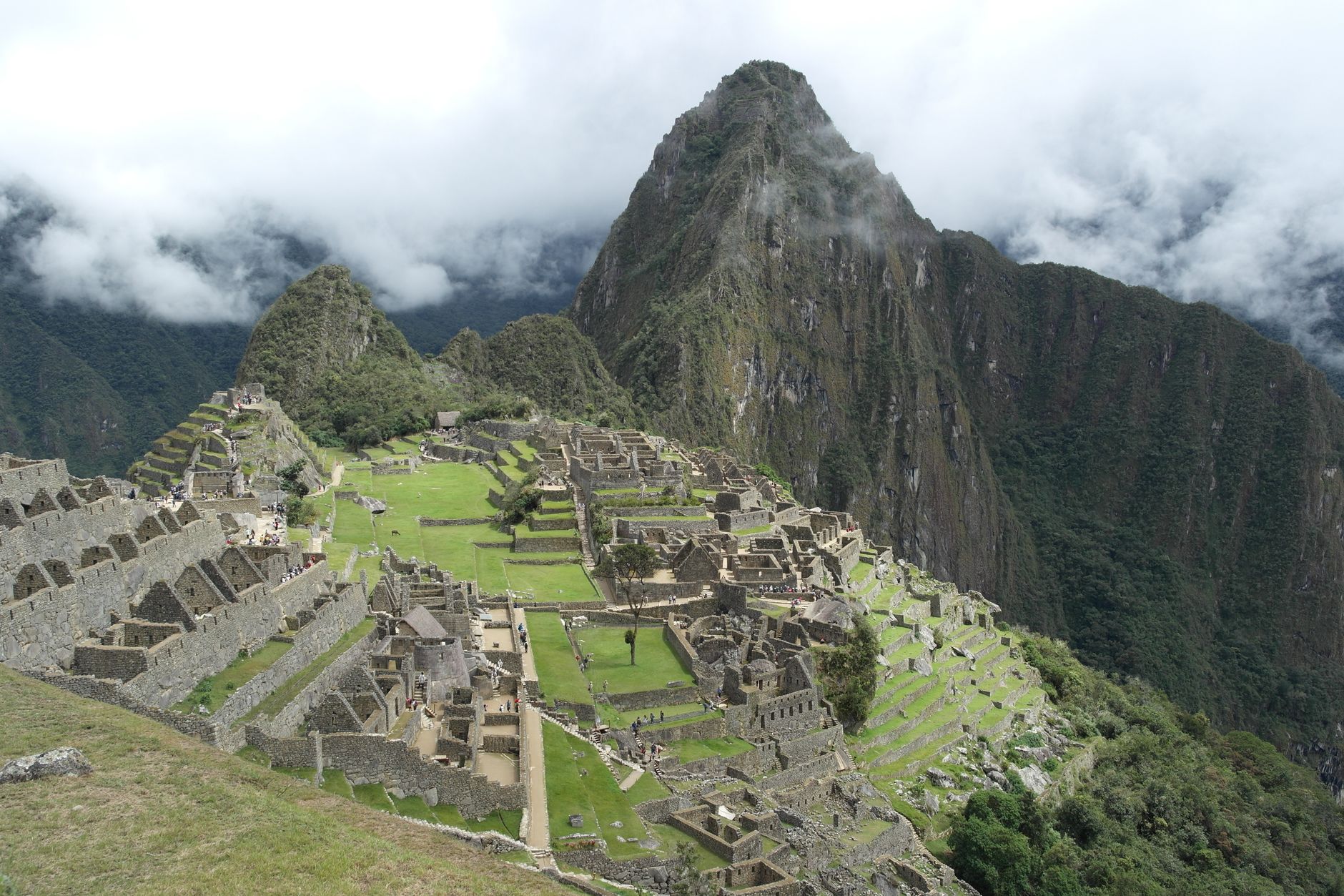 Breathtaking aerial view of Machu Picchu surrounded by misty mountains in Peru. Iconic ancient Inca site shrouded in mystery.
