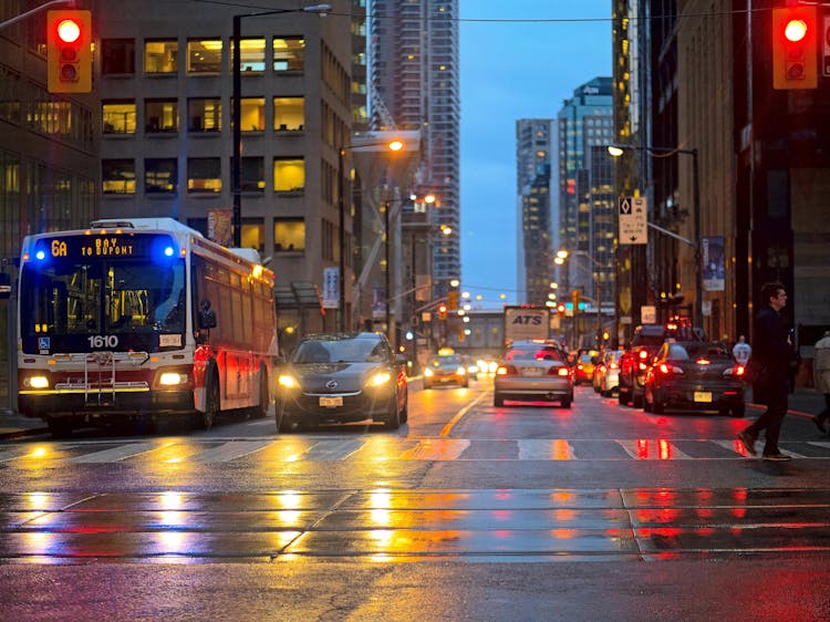 A Man Crossing The Street In The City