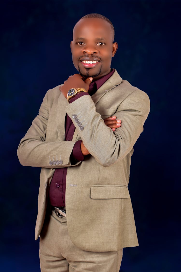 A Smiling Man In Beige Coat And Gold Watch