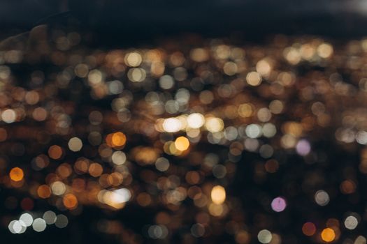 A mesmerizing cityscape with blurred bokeh effect, capturing colorful lights at night.