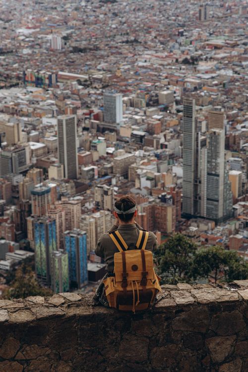 Traveller above a wide cityscape — photo by Yura Forrat on Pexels