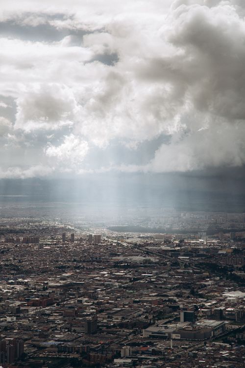 Free Aerial cityscape with dramatic clouds, showcasing an urban sprawl under moody skies. Stock Photo