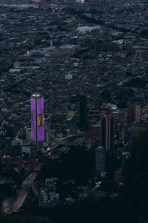 Free Stunning aerial view of a cityscape with illuminated skyscrapers during twilight. Stock Photo