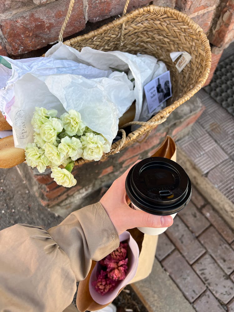 Hand Holding Takeout Coffee And Bag With Groceries