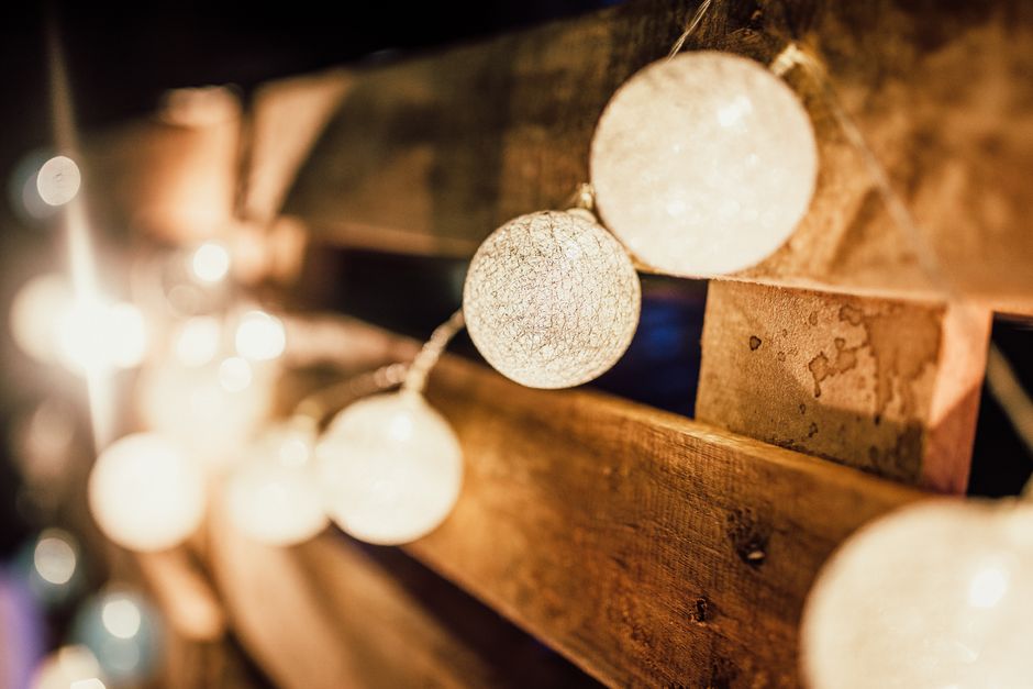 String Light Patio Canopy DIY home decor project — Cozy and warm atmosphere created by string lights against a wooden backdrop.