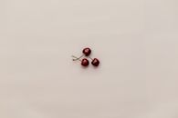 Three Red Cherry Fruits on White Surface