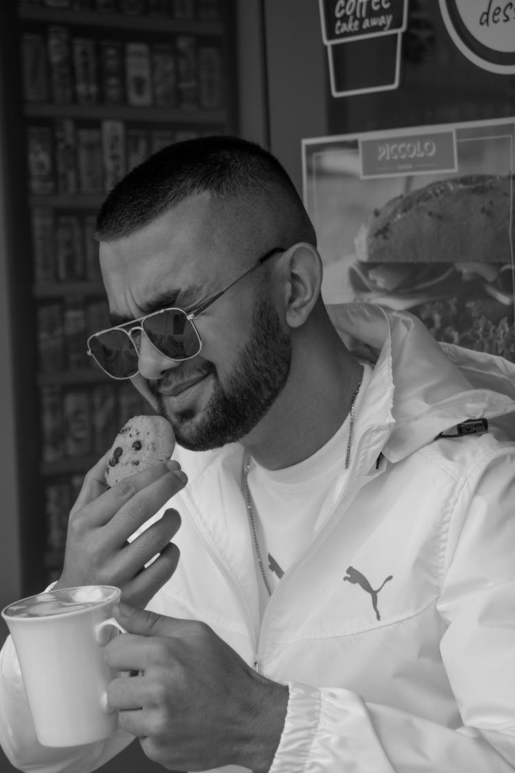 Black And White Photo Of A Man Eating Cookie