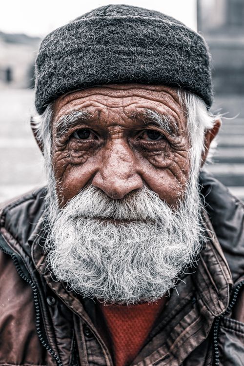 Free Close-up portrait of an elderly man with a white beard and warm hat in Tbilisi, Georgia. Stock Photo