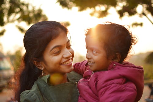 Close-Up Shot of a Woman Carrying Her Child