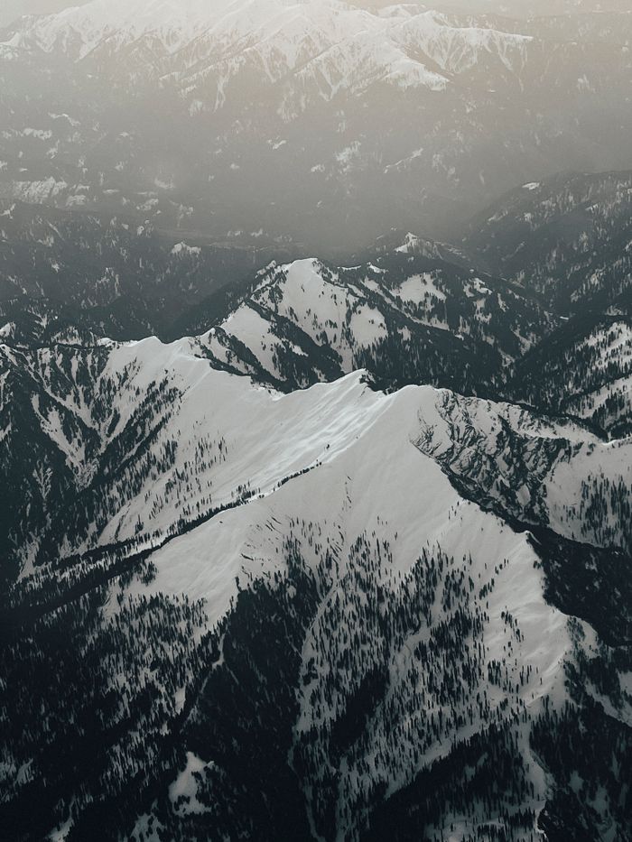 Aerial view of snow-covered mountains, photo by eric fotos on Pexels