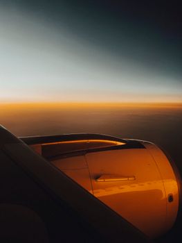 Stunning view of an airplane engine against a beautiful dusk sky, capturing the essence of modern travel.