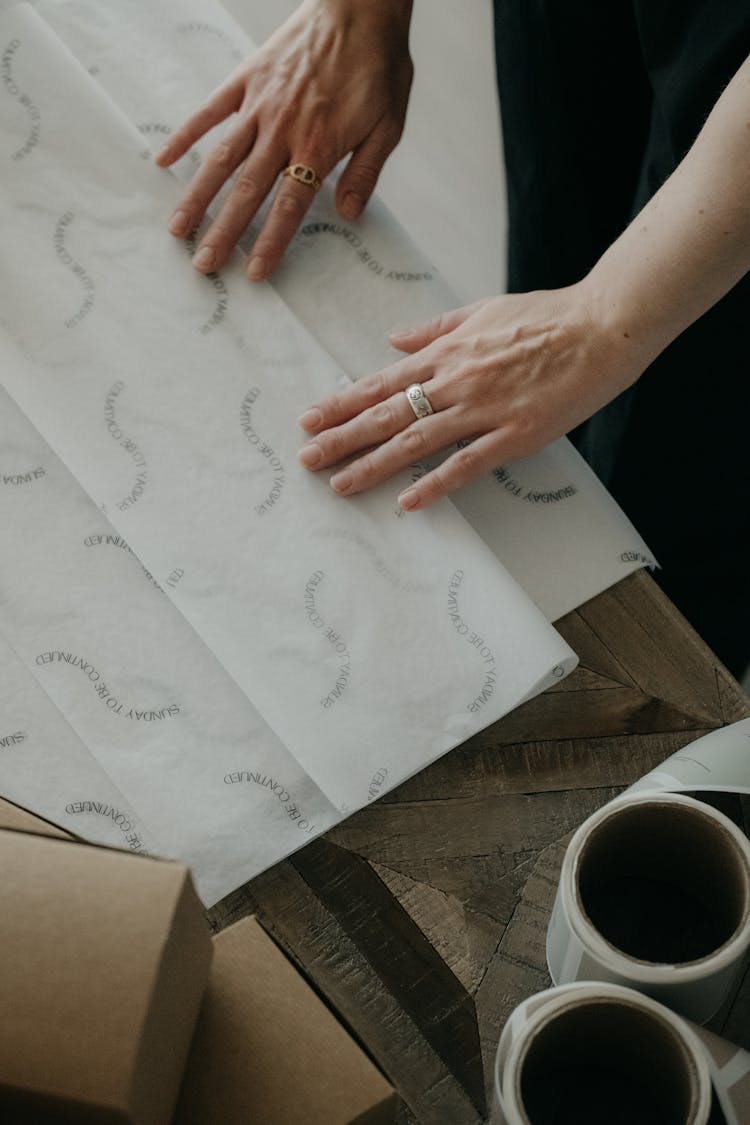 Hands Of Woman With Packing Paper