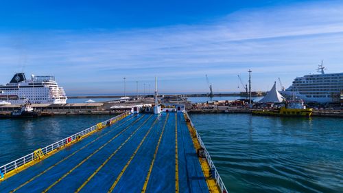 Free Colorful view of a busy port with cruise ships and docked vessels under a clear blue sky. Stock Photo