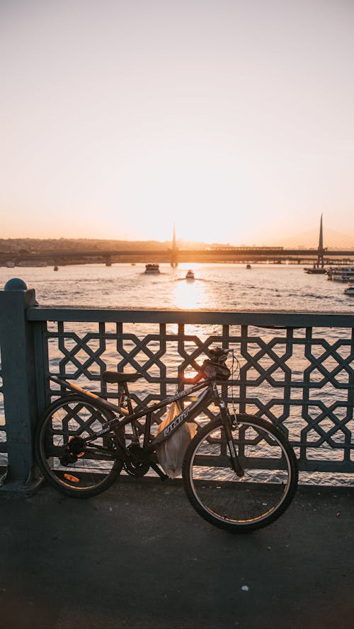 Free A Bicycle Parked on the Bridge Shoulder Stock Photo