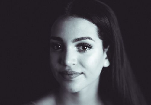 Free Close-up grayscale portrait of a young woman with a serene expression. Stock Photo