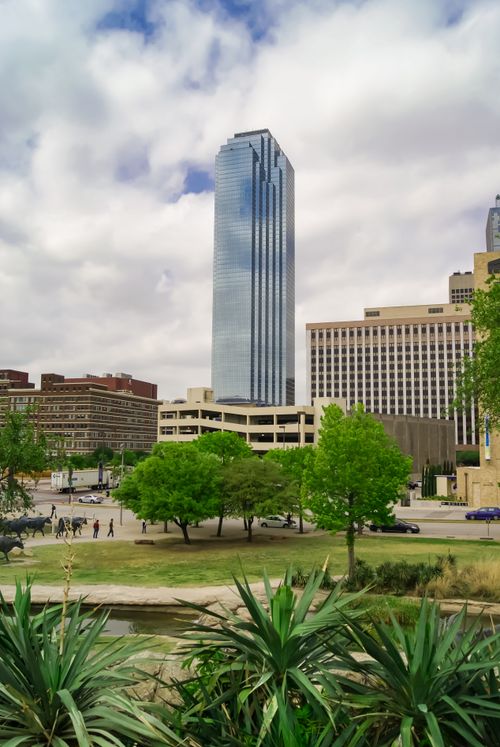 Free Tall skyscraper against cloudy sky with urban park in downtown Dallas, Texas. Stock Photo