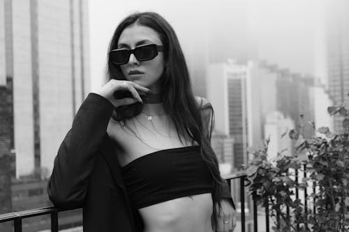A Beautiful Woman in Black Coat and Dark Sunglasses