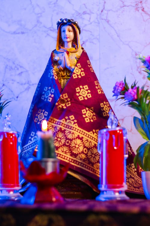 Photo of a Figure of a Virgin Mary on a Home Altar