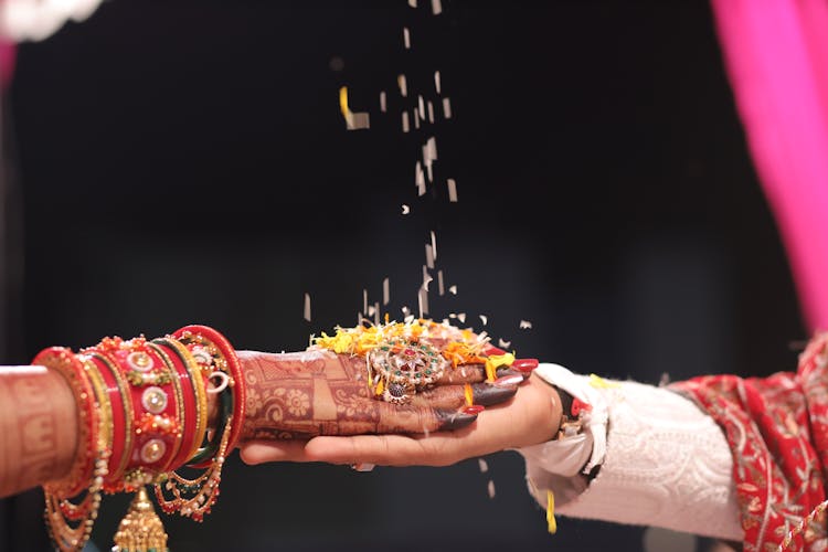 Close-up Of Couple Hands At Traditional Wedding