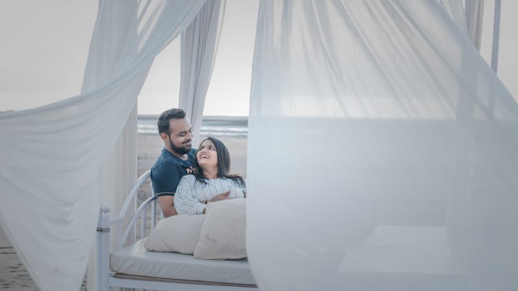 A Couple On A Bed At The Beach